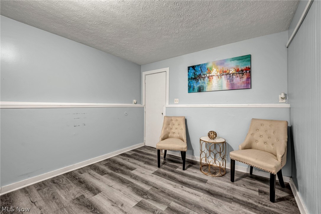 54 Park Road Painesville, OH 44077 - Photo 17 of 38 Living area featuring wood finished floors and a textured ceiling