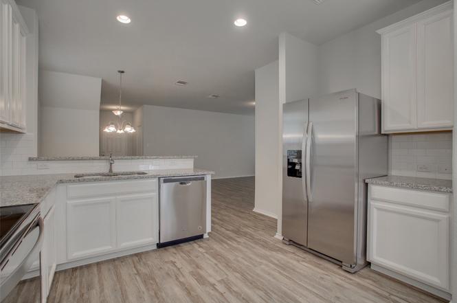 148 Spotted Rail Ridge Leander, TX 78641 - Photo 12 of 31 A well-appointed kitchen features stainless steel appliances and abundant counter space.