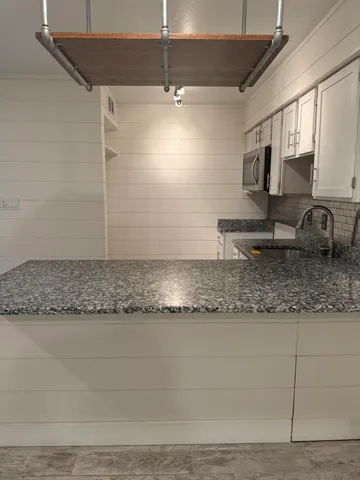 a view of a kitchen counter top space and cabinets