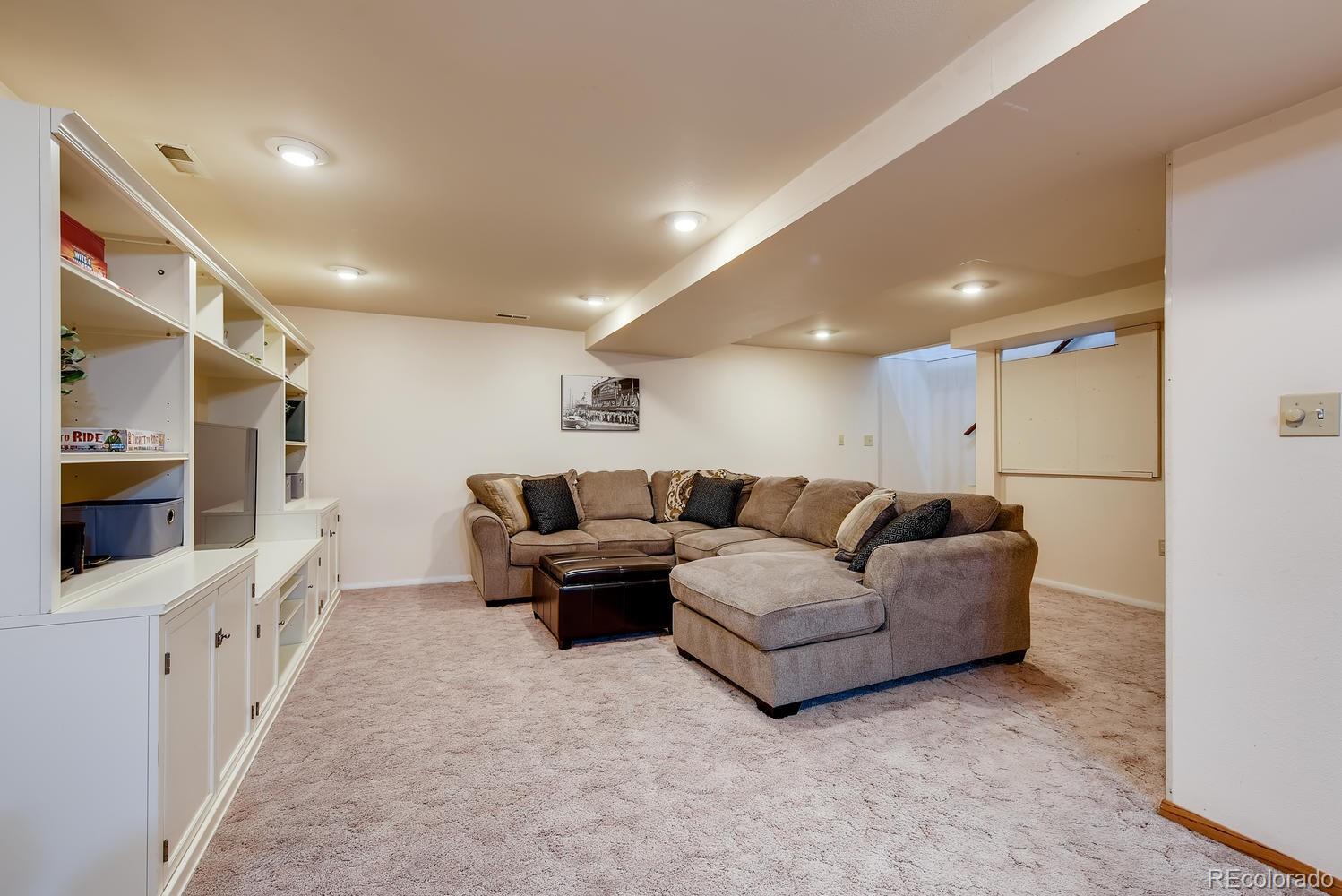 2621 Paseo Road Colorado Springs, CO 80907 - Photo 16 of 27 a living room with furniture and a flat screen tv