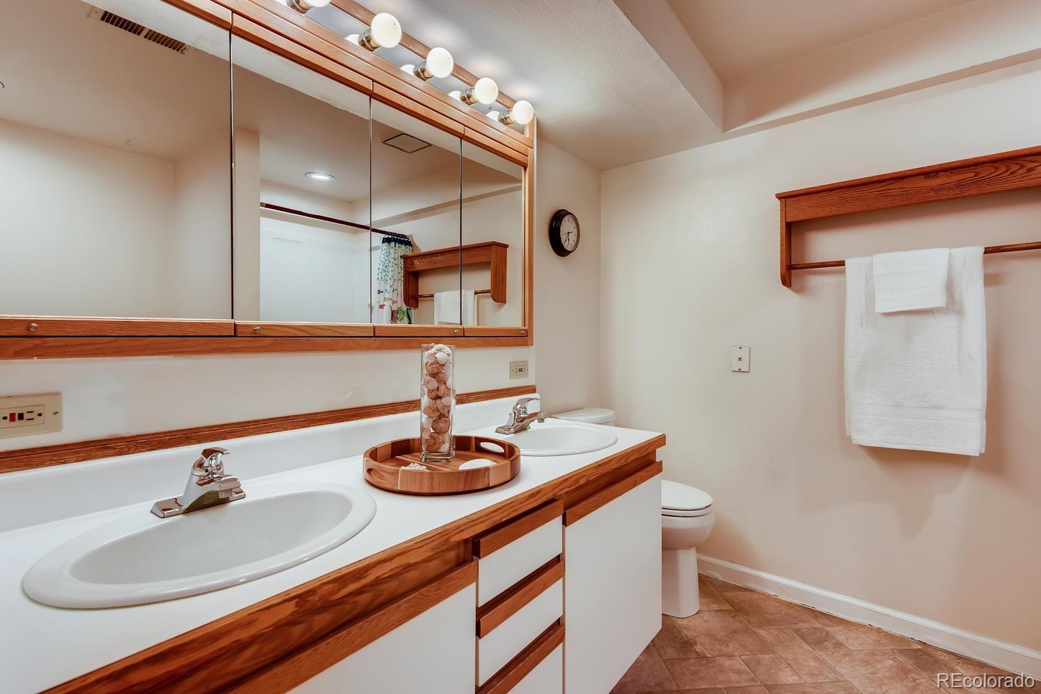 2621 Paseo Road Colorado Springs, CO 80907 - Photo 17 of 27 a bathroom with a sink double vanity and a mirror