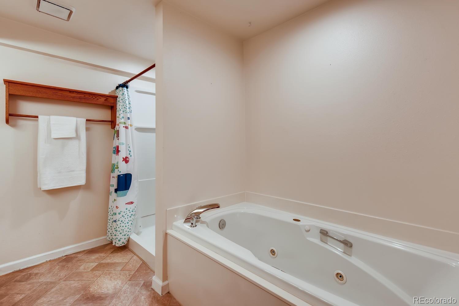 2621 Paseo Road Colorado Springs, CO 80907 - Photo 18 of 27 a bathroom with a tub sink and mirror
