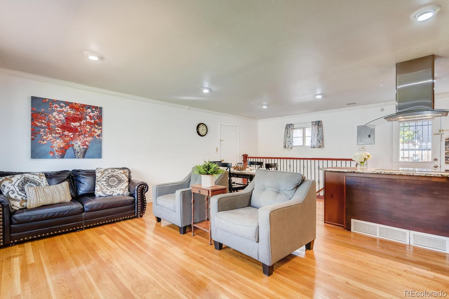 2621 Paseo Road Colorado Springs, CO 80907 - Photo 5 of 27 a living room with furniture and a wooden floor