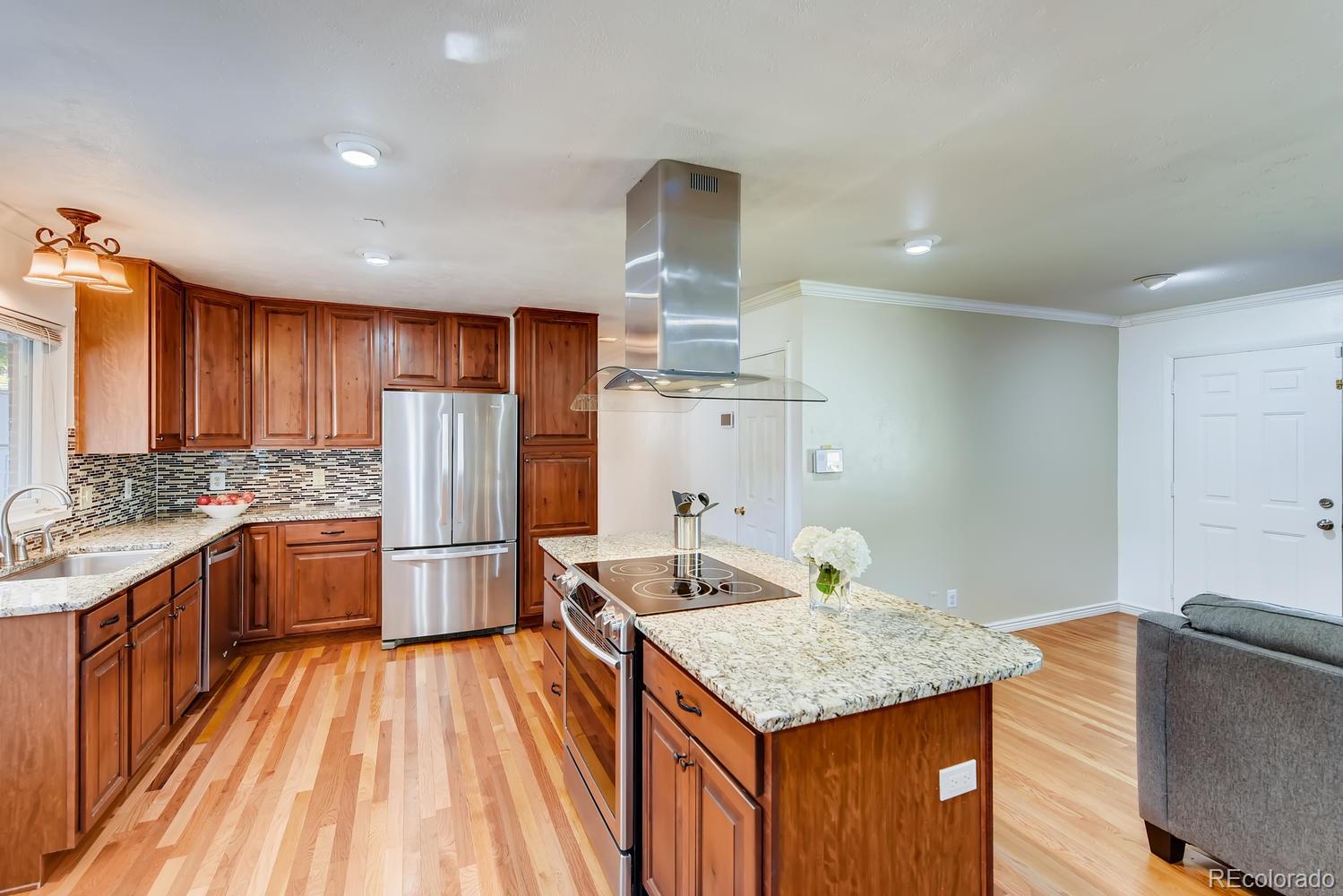 2621 Paseo Road Colorado Springs, CO 80907 - Photo 7 of 27 a kitchen with refrigerator sink and wooden cabinets