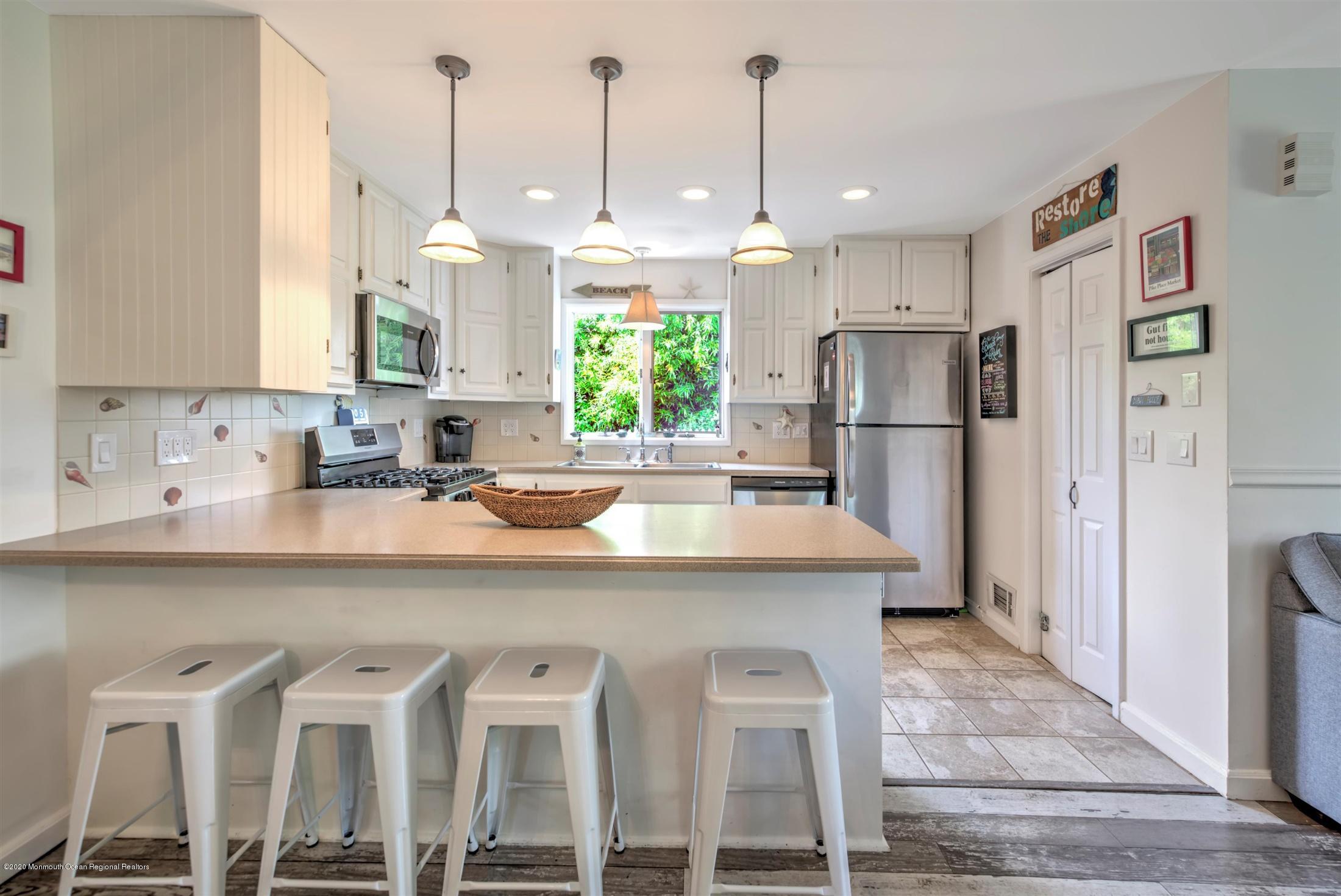 614 Ocean Road Spring Lake Heights, NJ 07762 - Photo 13 of 44 a kitchen with stainless steel appliances granite countertop a sink a stove a refrigerator and island