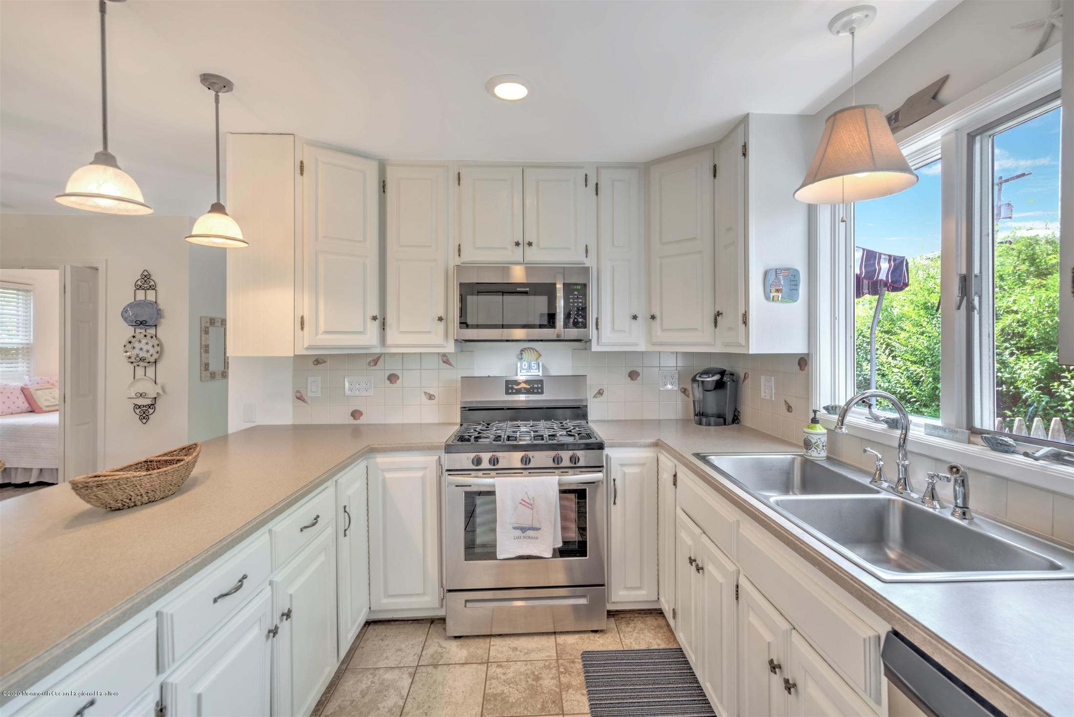 614 Ocean Road Spring Lake Heights, NJ 07762 - Photo 15 of 44 a kitchen with granite countertop a sink stainless steel appliances and cabinets