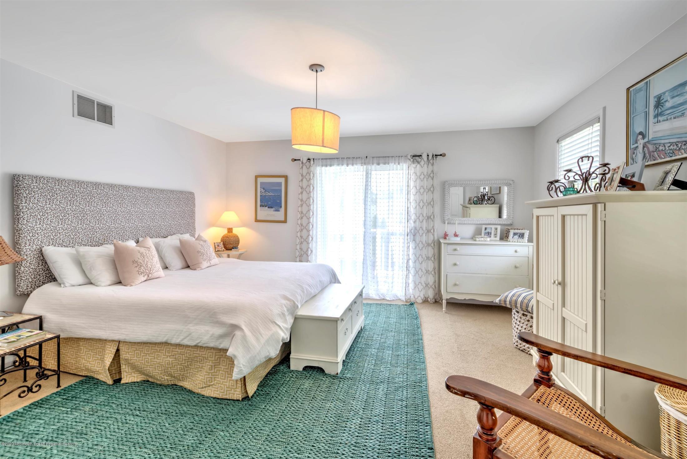 614 Ocean Road Spring Lake Heights, NJ 07762 - Photo 23 of 44 a bed room with a bed window and a chair