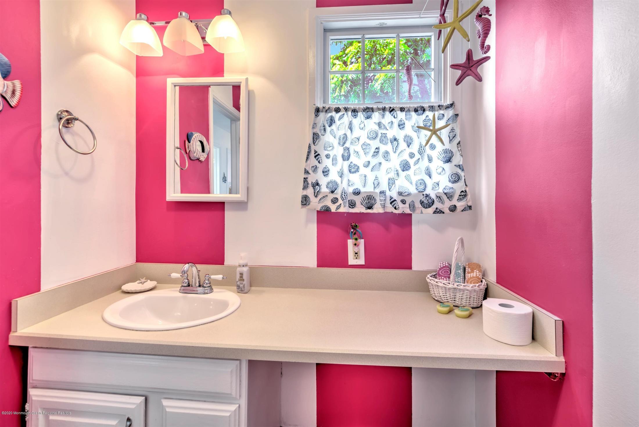 614 Ocean Road Spring Lake Heights, NJ 07762 - Photo 36 of 44 a bathroom with a sink vanity and a mirror