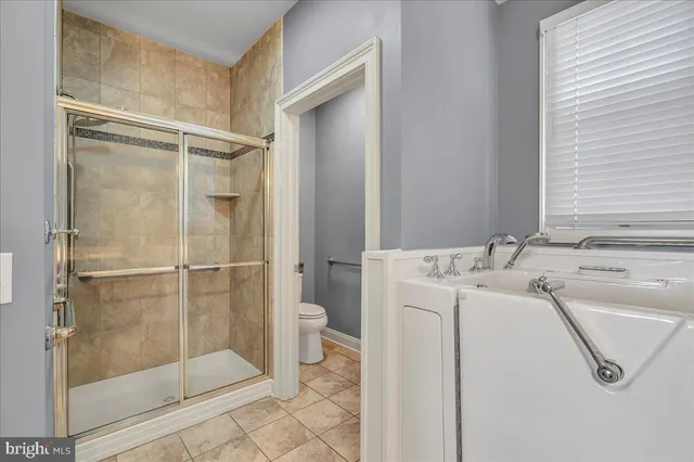 a bathroom with a shower a toilet and a sink