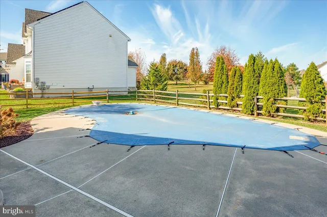 a view of an swimming pool with outdoor seating and yard
