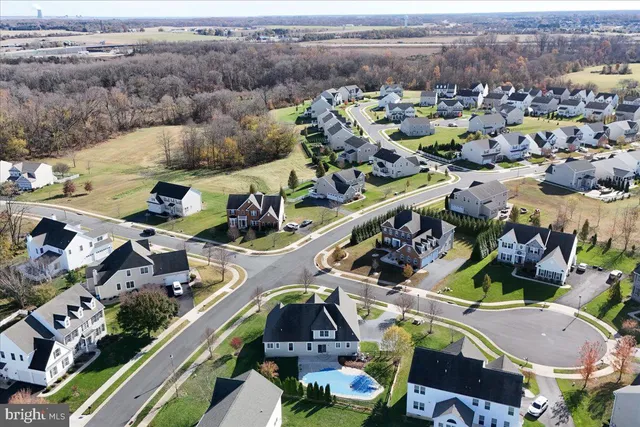 an aerial view of residential house with outdoor space and swimming pool
