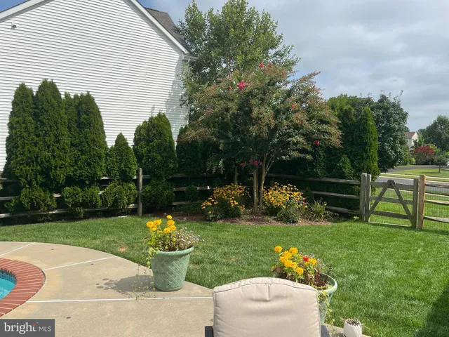 a backyard of a house with lots of green space and lake view