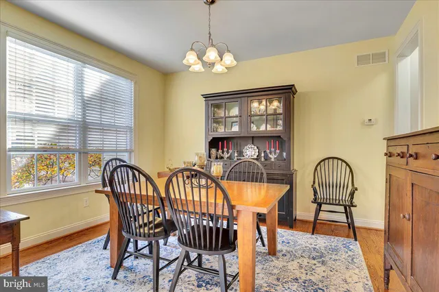 a view of a dining room with furniture and chandelier