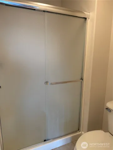 a bathroom with a shower and a toilet