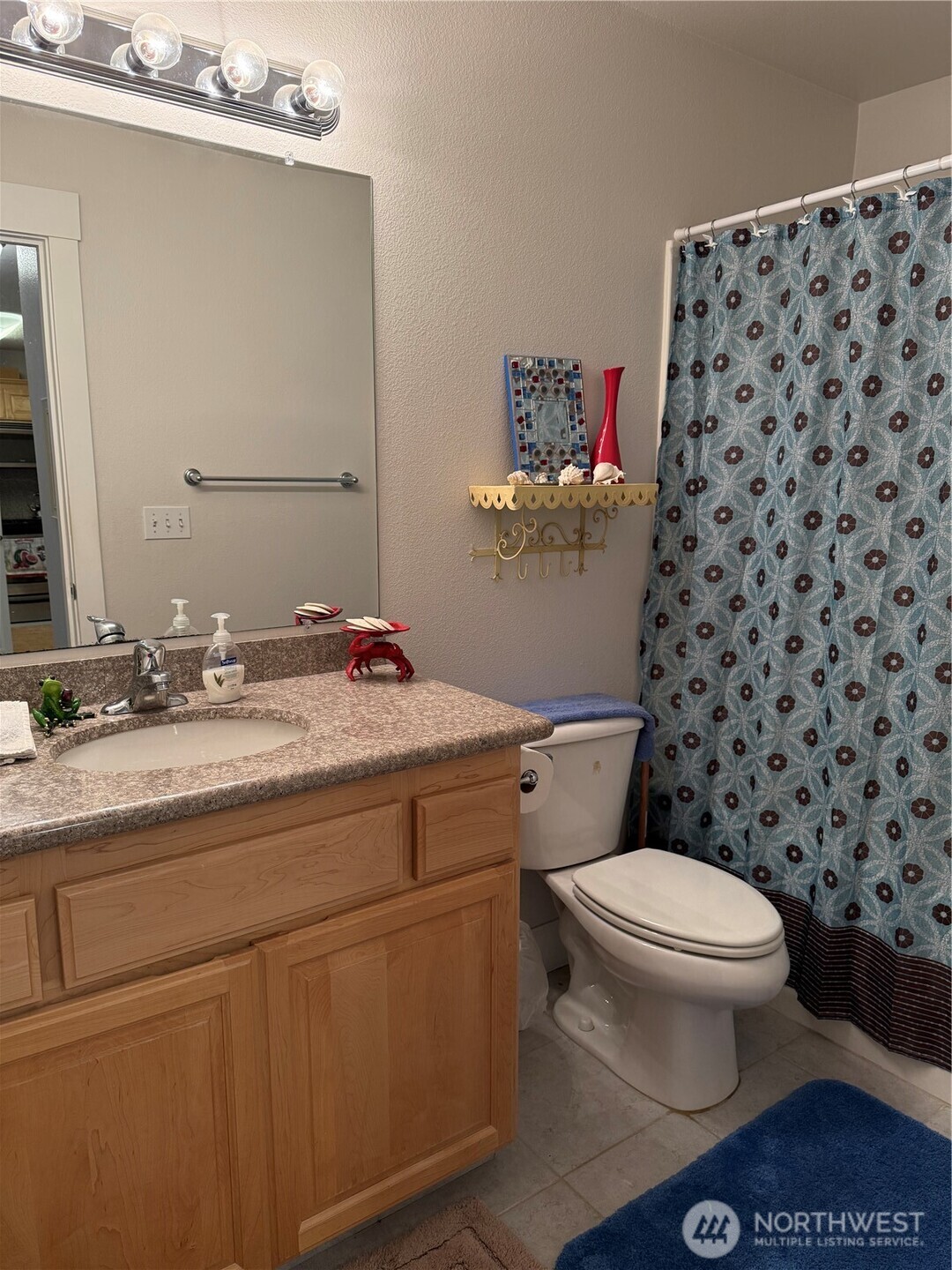 2815 Willows Road, Unit 116 Seaview, WA 98644 - Photo 26 of 30 a bathroom with a granite countertop toilet a sink and a mirror