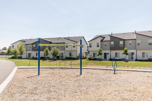 349 West 3085 South Logan, UT 84321 - Photo 35 of 37 Community playground area featuring a wood chip surface and a swing set