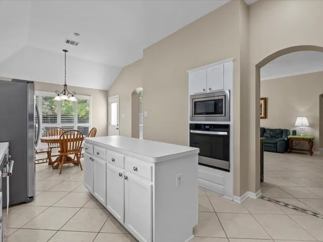 a kitchen with a sink cabinets and window
