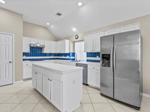 a dining room with furniture a chandelier and window