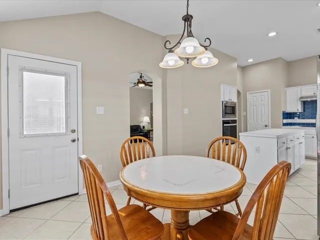 a bedroom with a large bed dresser and wooden floor