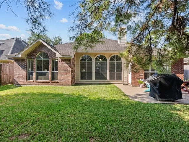 an aerial view of a house with a yard and lake view