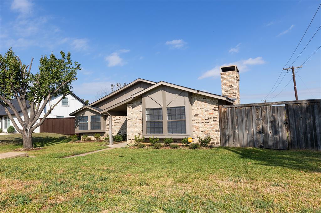 1031 East Peters Colony Road Carrollton, TX 75007 - Photo 2 of 21 a front view of a house with garden