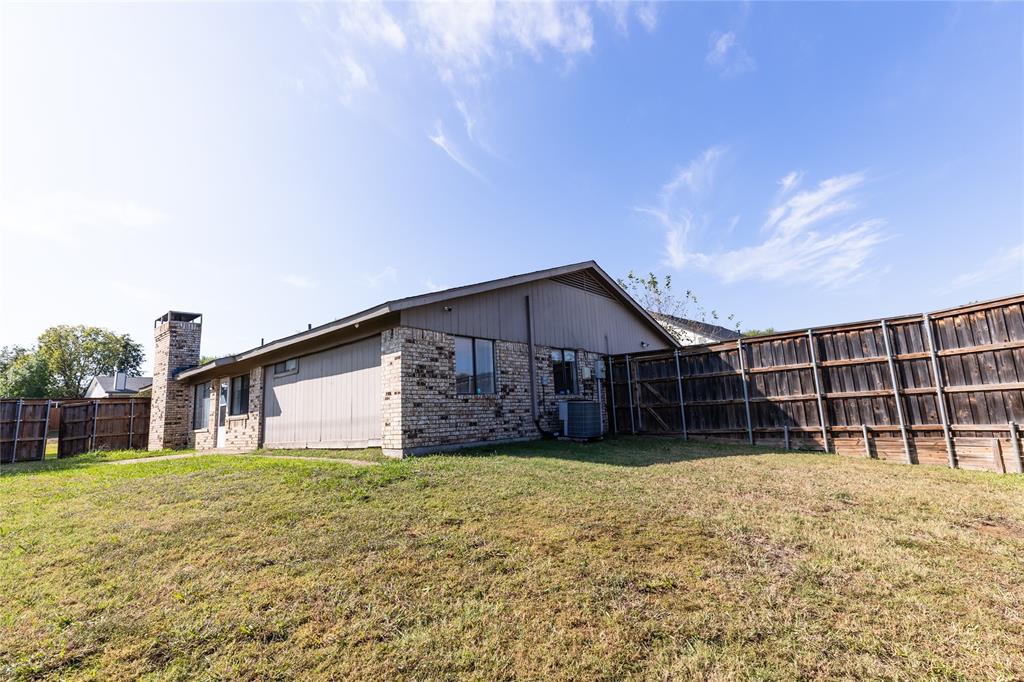 1031 East Peters Colony Road Carrollton, TX 75007 - Photo 21 of 21 a view of a house with a yard