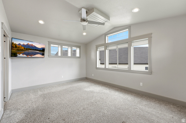 560 Aspen Road Francis, UT 84036 - Photo 42 of 59 Vaulted ceiling with a contemporary ceiling fan, recessed lighting, wall-mounted television, multiple windows, and light-toned carpeting