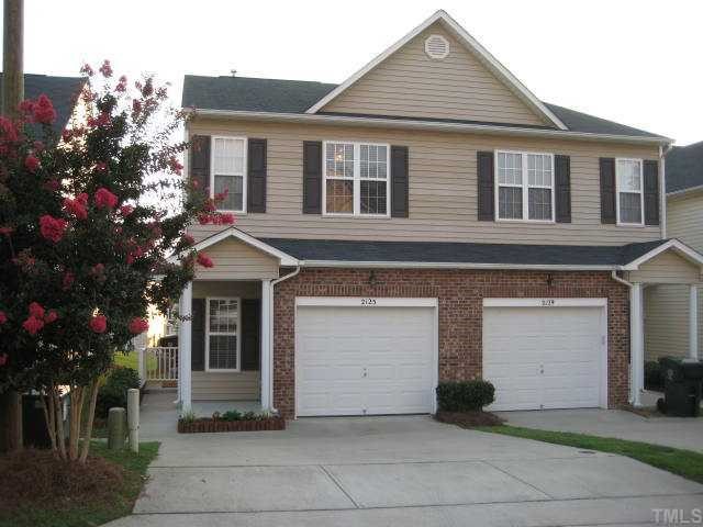 2125 Persimmon Ridge Drive Raleigh, NC 27604 - Photo 1 of 12 a front view of a house with a yard and garage