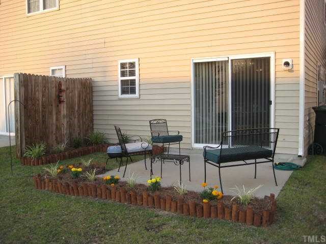 2125 Persimmon Ridge Drive Raleigh, NC 27604 - Photo 11 of 12 a backyard of a house with yard and outdoor seating