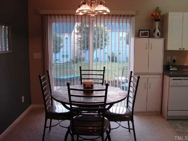 2125 Persimmon Ridge Drive Raleigh, NC 27604 - Photo 4 of 12 a view of a dining room with furniture and a chandelier