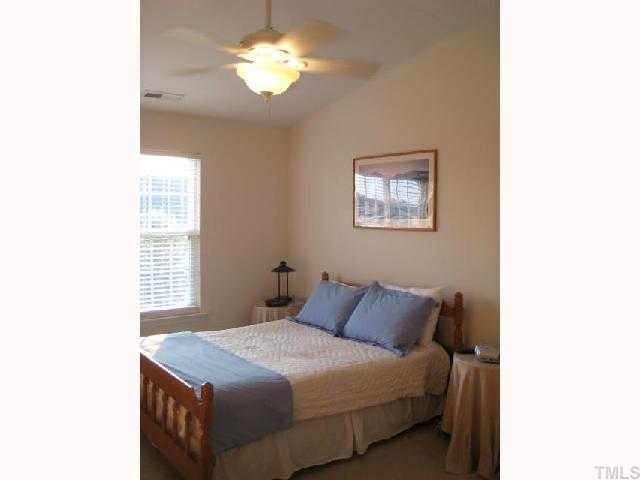 2125 Persimmon Ridge Drive Raleigh, NC 27604 - Photo 6 of 12 a bedroom with a bed and a chandelier