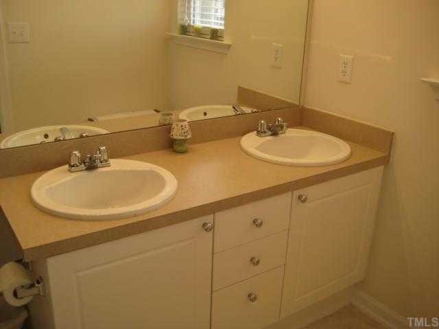 2125 Persimmon Ridge Drive Raleigh, NC 27604 - Photo 7 of 12 a bathroom with a sink and a mirror