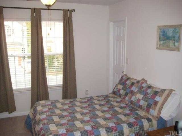 2125 Persimmon Ridge Drive Raleigh, NC 27604 - Photo 8 of 12 a bedroom with a bed and a window