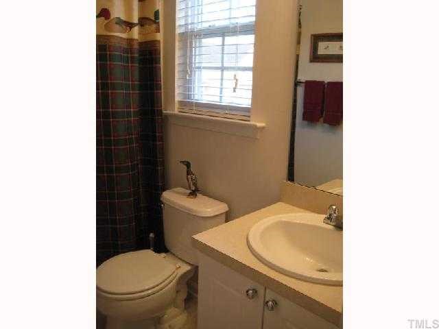 2125 Persimmon Ridge Drive Raleigh, NC 27604 - Photo 9 of 12 a bathroom with a toilet a sink and a window