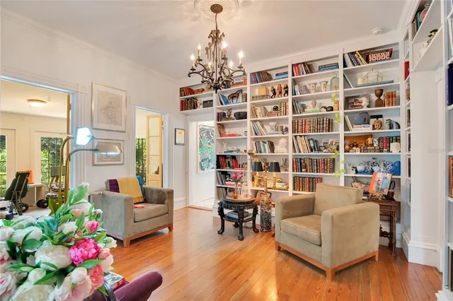 a living room with furniture chandelier and a fireplace
