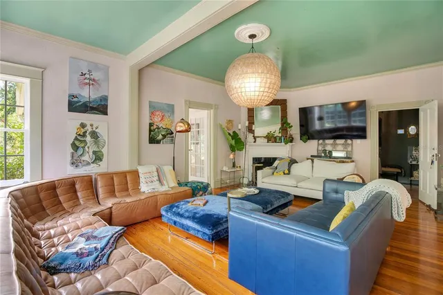 a living room with lots of furniture and a chandelier