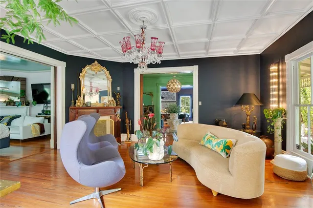 a living room with furniture and a floor to ceiling window