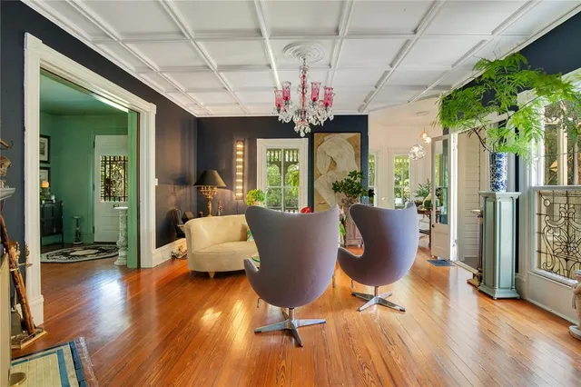 a kitchen with stainless steel appliances kitchen island granite countertop a table chairs in it and wooden floors