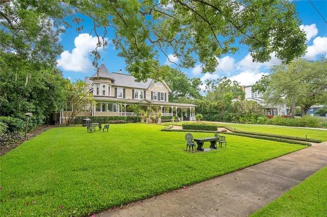a front view of a house with a yard table and chairs