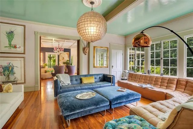 a spacious bedroom with a bed and a chandelier