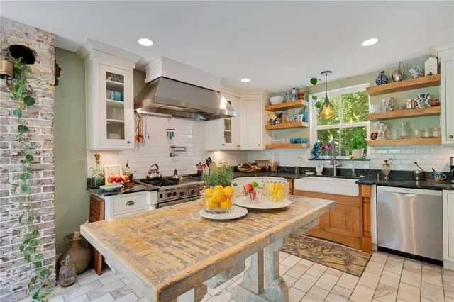 a living room with furniture a flat screen tv and a potted plant