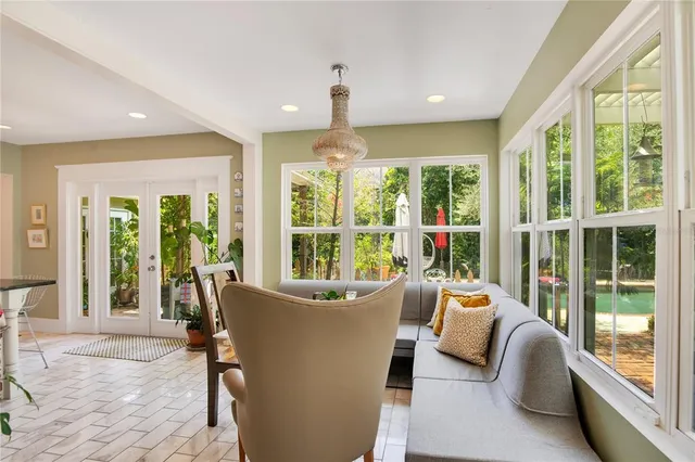 a bedroom with a bed a flat screen tv and dresser