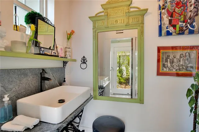 a bathroom with a sink a mirror and a shower