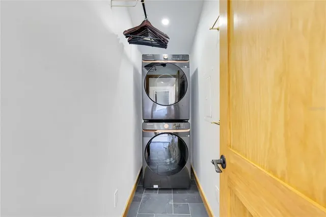 a living room with furniture and a fireplace with bookshelf