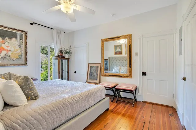 a backyard of a house with basket ball court tables and chairs