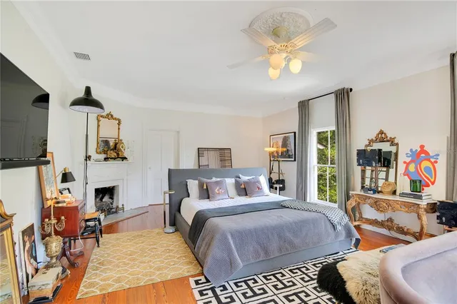 an aerial view of a house with swimming pool and trees