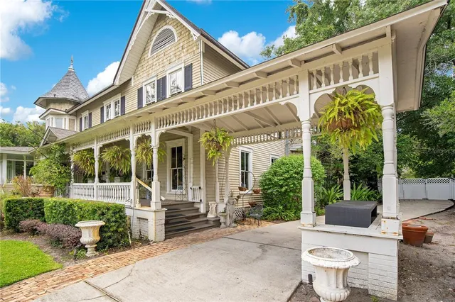 a living room with fireplace furniture and a chandelier