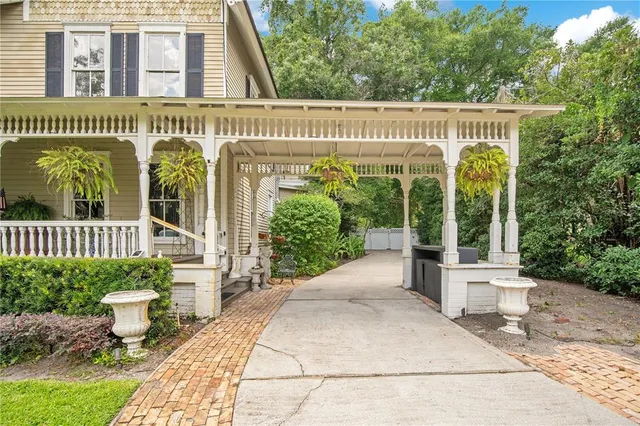 a living room with furniture hard wood floor and a chandelier