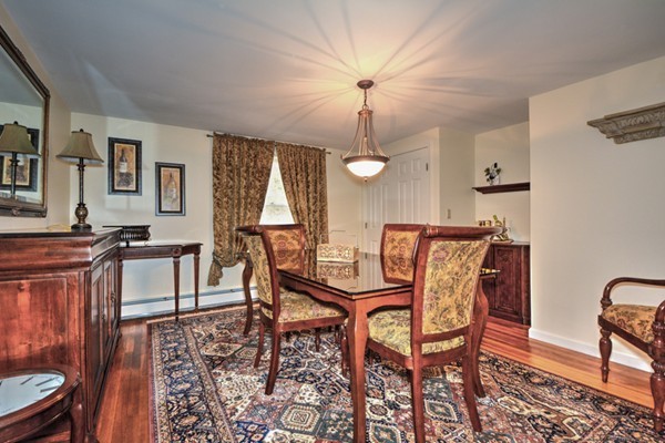 12 Williams Road Sturbridge, MA 01566 - Photo 13 of 30 a dining room with furniture a chandelier and wooden floor