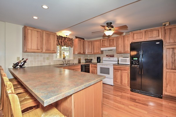 12 Williams Road Sturbridge, MA 01566 - Photo 4 of 30 a kitchen with stainless steel appliances granite countertop a refrigerator a sink dishwasher a stove and a refrigerator with wooden floor